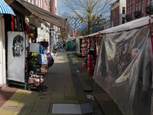 2023 Amsterdam - a view behind the market stalls at the street Albert Cuypstraat, in the sunlight of March - free download photo in Dutch street photography by Fons Heijnsbroek, Netherlands.tif