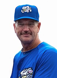 A man in a blue baseball uniform and hat