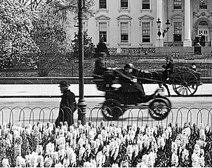 Columbia Electric's (1896–99) "Victoria" electric cab on Pennsylvania Ave., Washington D.C., seen from Lafayette Square in 1905, driving in front of the White House.