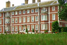 A photograph of the rear of the house from the gardens, illustrating newer brickwork from the renovation in the 1670s