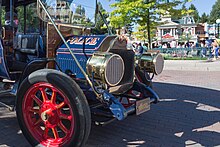 A blue turn-of-the-20th-century-style police van