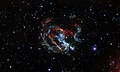 Featured in this Hubble image is an expanding, gaseous corpse — a supernova remnant — known as 1E 0102.2-7219.[3]