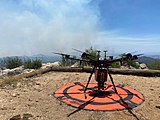 An unmanned aircraft system (UAS) conducting aerial ignitions to control the fire