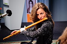 A woman playing bansuri