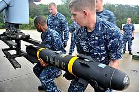 US Navy 110921-N-YG591-096 Aviation Ordnancemen place a Hellfire missile on an MH-60 Sea Hawk helicopter.jpg