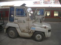 A photo that shows text on both sides of a China Post vehicle. On the right door, china post appears as tsop anihc.