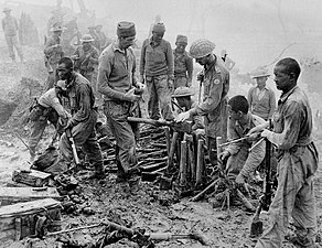 Indian troops inspect captured Japanese ordnance