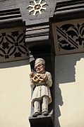 Relief carvings adorn some half-timbered buildings.