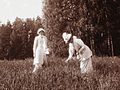 Grand Duchess Tatiana and her mother, Tsarina Alexandra pick flowers in about 1914.