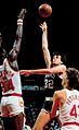 Kevin McHale jumping over Hakeem Olajuwon