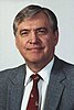 man with gray hair in a gray business suit