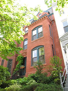 A late 19th-century red brick Victorian row house