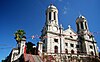 St. John's Cathedral, view of the front with twin tall domed towers topped by crosses flanking the entrance