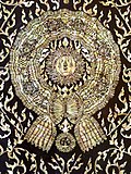 A mother-of-pearl inlay of "Maha Surabhorn", the Knight Grand Cross (First Class) of the Order of the Crown of Siam, version that was used from 1869 to 1909, at the gates of Phra Uposatha of Wat Ratchabophit Sathit Maha Simaram, Bangkok.