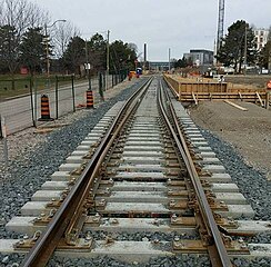 Gauntlet track at station where regular freight trains pass as well