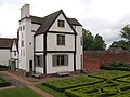 The hunting lodge, framed by its own chimney stack and stairway.