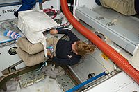 Sandra Magnus in toe socks (STS-135).