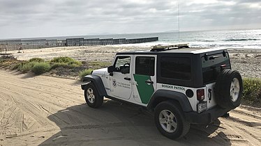 A CBP Border Patrol vehicle sitting near Mexico–U.S. border