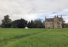 Photograph of the castle showing part of the gardens