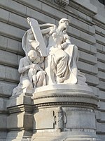 Marble statue of a seated woman holding a tablet