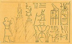 Drawing in black ink on yellow paper showing a standing pharaoh, staff in hand, surrounded by hieroglyphs