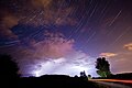 The constellation of Cassiopeia over a thunderstorm.[3]