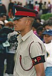 Royal Bermuda Regiment Regimental policeman in No. 2 Dress khaki shirt, without tie, and No. 1 Dress cap.