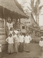 A group of local women wearing sarong and kebaya at the entrance of traditional house in a village at Minahasa, North Sulawesi, Indonesia c. 1900