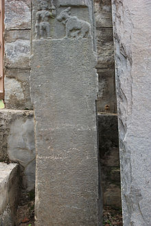 An inscribed stone, with a man and an animal