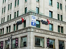 Global Montreal signs on the lower floors of a limestone-faced office building.