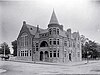 B&w photograph of a building in Queen Anne architectural style