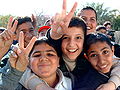 Iraqi boys making the V sign in Baghdad.