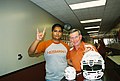 Mack Brown and fan with signed helmets