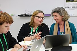 Editors discussing Wikipedia updates at Edit for Equity event in Wellington, New Zealand.