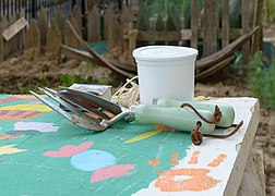 Petits outils de jardinage : fourche à fleurs et transplantoir.