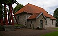 Kälvene kyrka med klockstapeln stående på en möjlig gravhög, Västergötland.