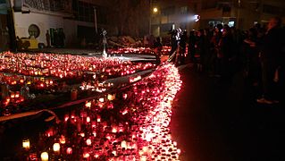 Candles and wreaths at the site of Club Colectiv