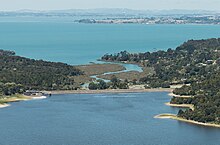 Lower Nihotupu Dam and Manukau Harbour (cropped).jpg