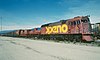 Rust-red locomotive with smooth front in rail yard