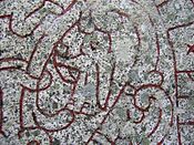 A female figure bearing a horn on runestone U 1163.