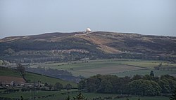 A shot looking across to a small radome, on a hill, in the distance