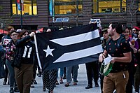 Black La Monoestrellada at the Solidarity with Puerto Rico Rally in Chicago (2018)