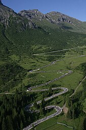 A winding road on the slopes of a mountain.