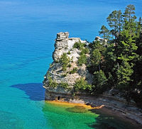 Rounded rock tower jutting into the lake