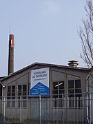 Fabriekscomplex met daarachter fabrieksschoorsteen aan de Gedempte Hamerkade van voormalige IJzergieterij De Etna later overgenomen door Stork.