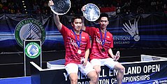 Marcus Fernaldi Gideon and Kevin Sanjaya Sukamuljo pose at the 2017 All England Open podium