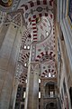 Details in the pillars of mosque, including red and white ablaq in the arches and muqarnas on the pillars and on the pendentives