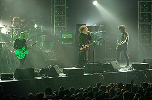 The Cure performing in August 2007. From left to right: Jason Cooper (on drums), Porl Thompson, Robert Smith, and Simon Gallup.