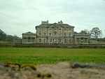 Hickleton Hall with attached Quadrant Walls and Walls extended to enclose Entrance Front Garden with associated Gate Piers and Statues