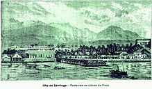 Green-tinted photo of water, boats, buildings and mountains